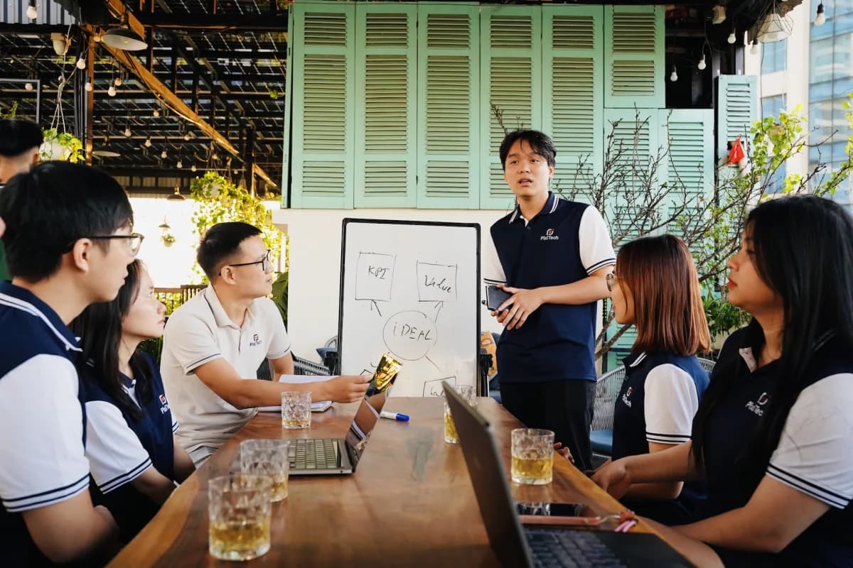 PixiTech team planning around a whiteboard